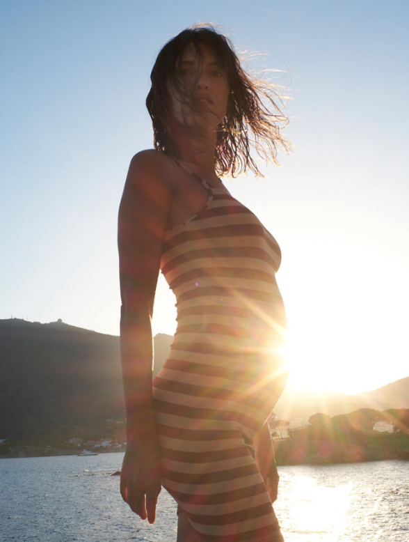Pregnant woman in the sun wearing tube dress