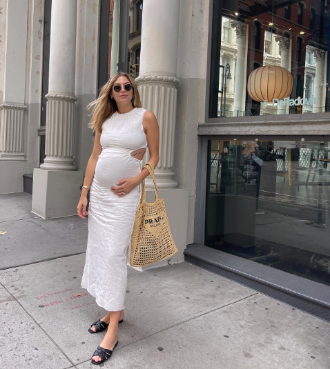 Pregnant influencer wearing white maternity dress insta account