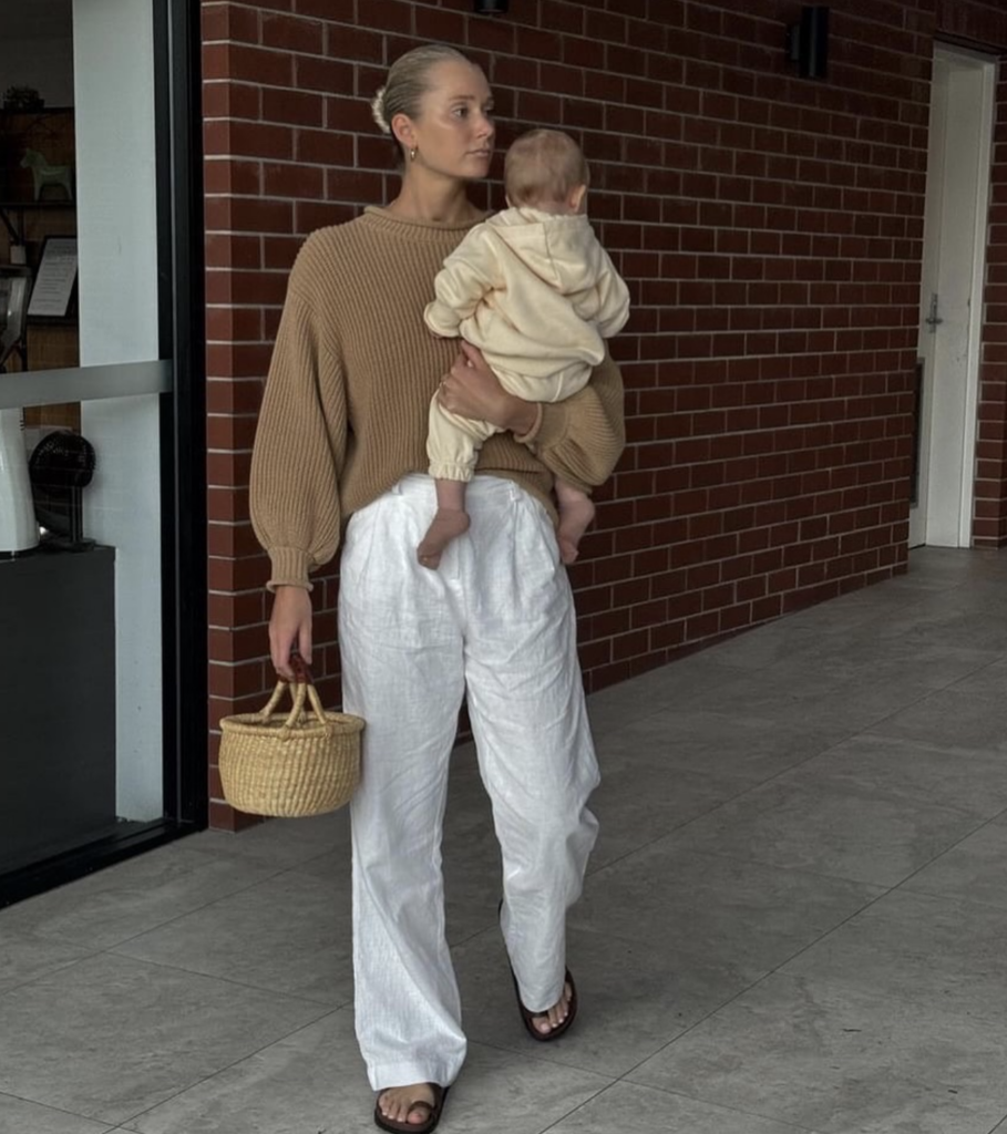 White linen wide leg pants with brown jumper and raffia bag